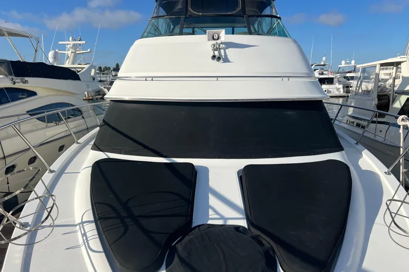 Slide: The Image of 2004 Carver 466 MY yacht docked at marina, featuring sleek design and spacious deck. - 21