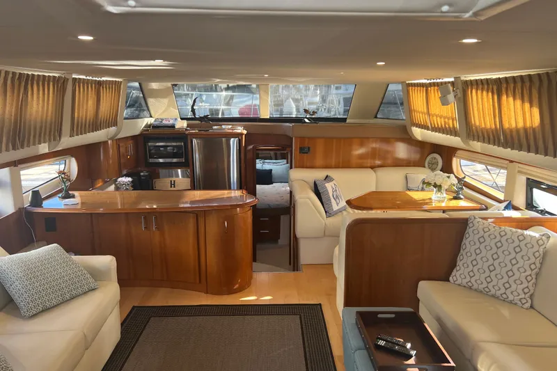 Slide: The Image of Luxurious interior of a 2004 Carver 466 MY yacht with elegant wood finishes and plush seating. - 23