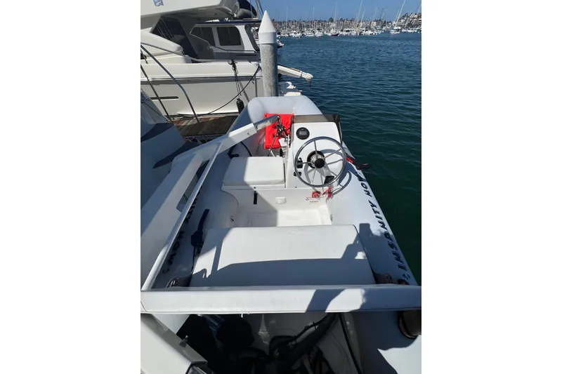 Slide: The Image of 2004 Carver 466 Motor Yacht docked, featuring a sleek white deck and steering wheel. - 39