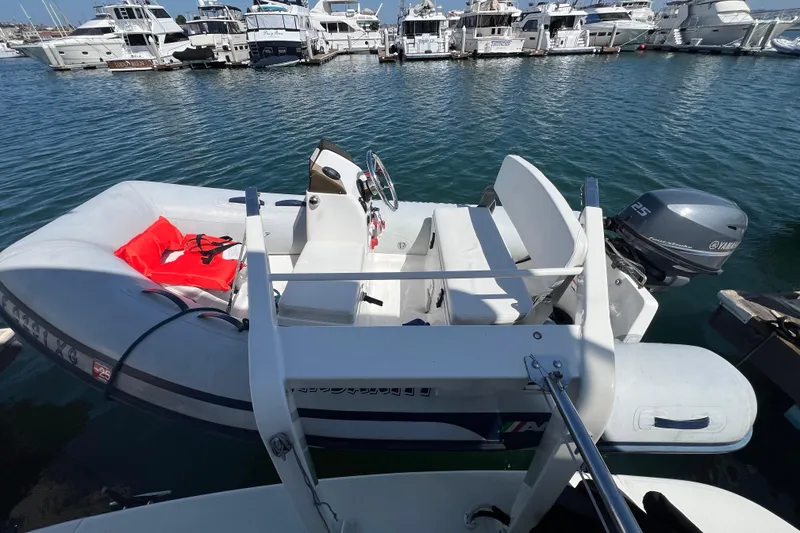 Slide: The Image of Inflatable boat with Yamaha motor docked near Carver 466 Motor Yacht, 2004 model. - 40