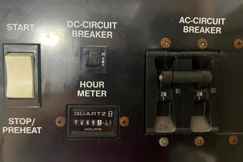 Slide: The Image of Control panel of a 2004 Carver 466 Motor Yacht with circuit breakers and hour meter. - 47