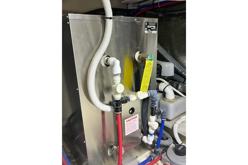 Slide: The Image of Engine room of 2004 Carver 466 Motor Yacht with plumbing and equipment. - 48