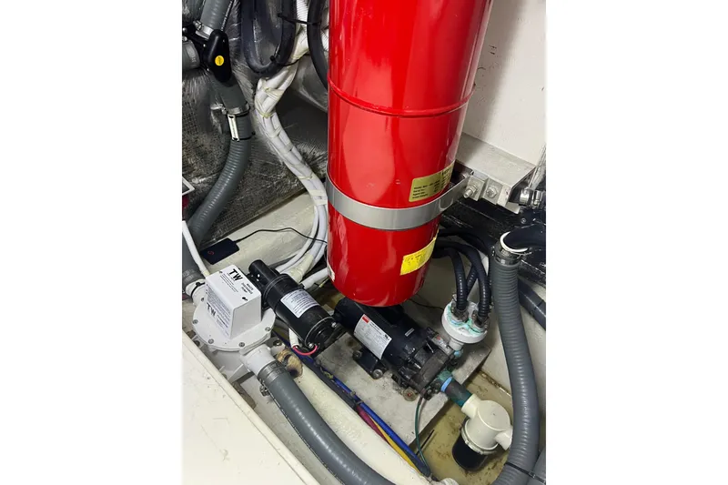 Slide: The Image of Engine room of 2004 Carver 466 MY with red fire extinguisher and mechanical components. - 53