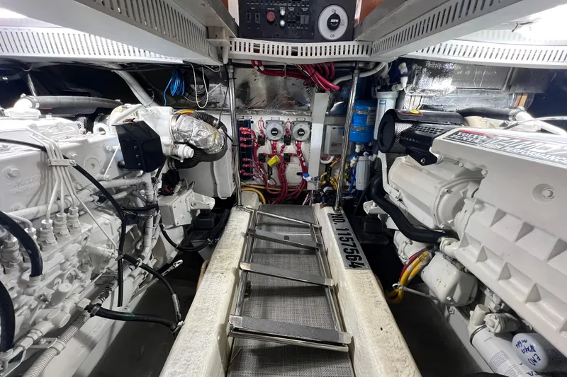 Slide: The Image of Engine room of 2004 Carver 466 MY yacht, showcasing dual engines and mechanical systems. - 64