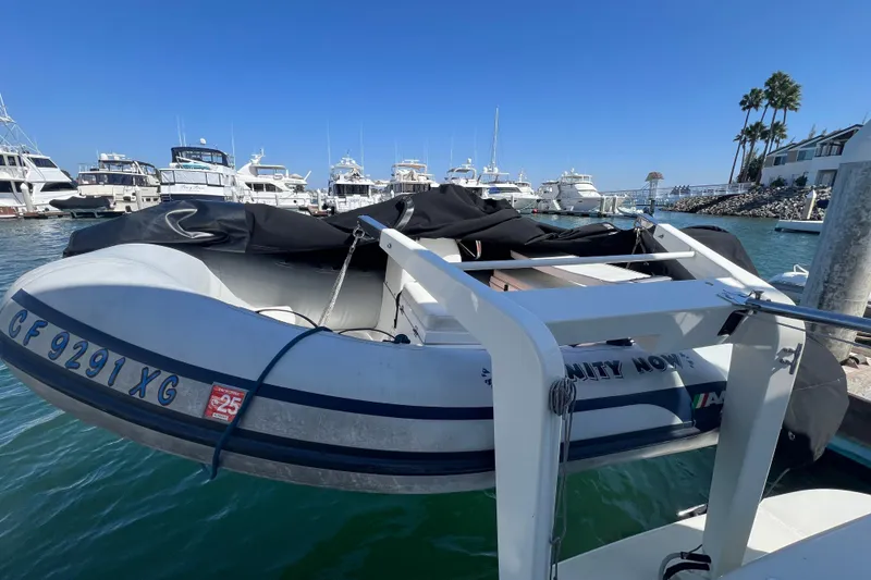 Slide: The Image of 2004 Carver 466 Motor Yacht docked with inflatable boat, marina background. - 67