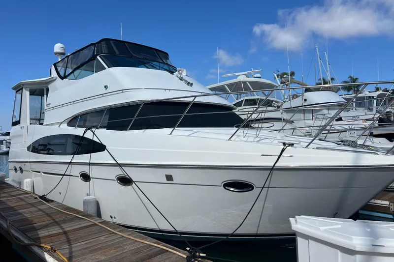 The Image of 2004 Carver 466 MY yacht docked at marina under clear blue sky. - 0