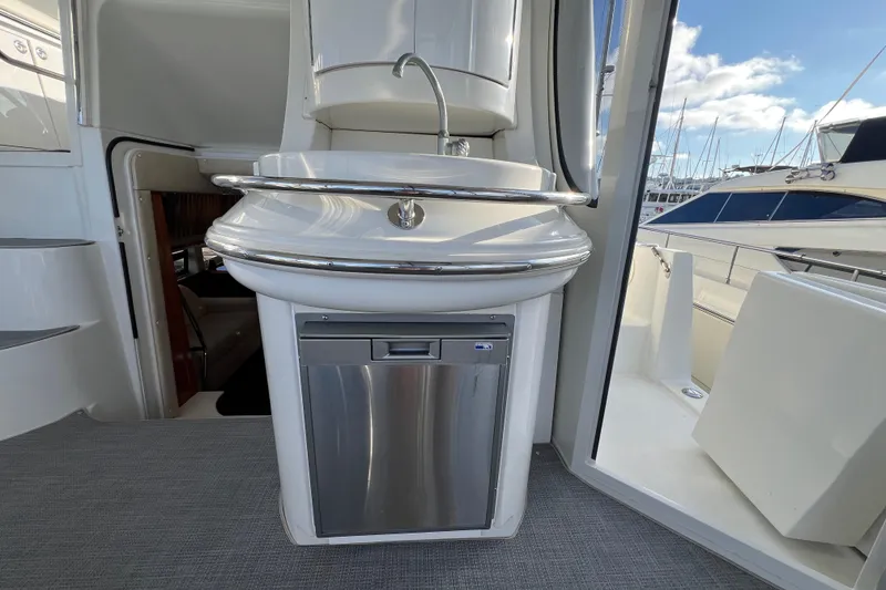Slide: The Image of 2004 Carver 466 MY yacht interior with sink and stainless steel appliance. - 17