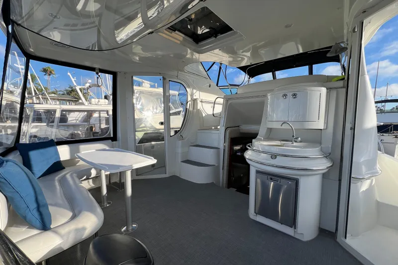Slide: The Image of Luxurious interior of 2004 Carver 466 MY yacht with seating, table, and kitchenette. - 19