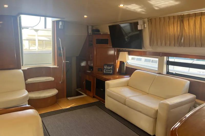 Slide: The Image of Luxurious interior of 2004 Carver 466 MY yacht with cream sofas and wood accents. - 26