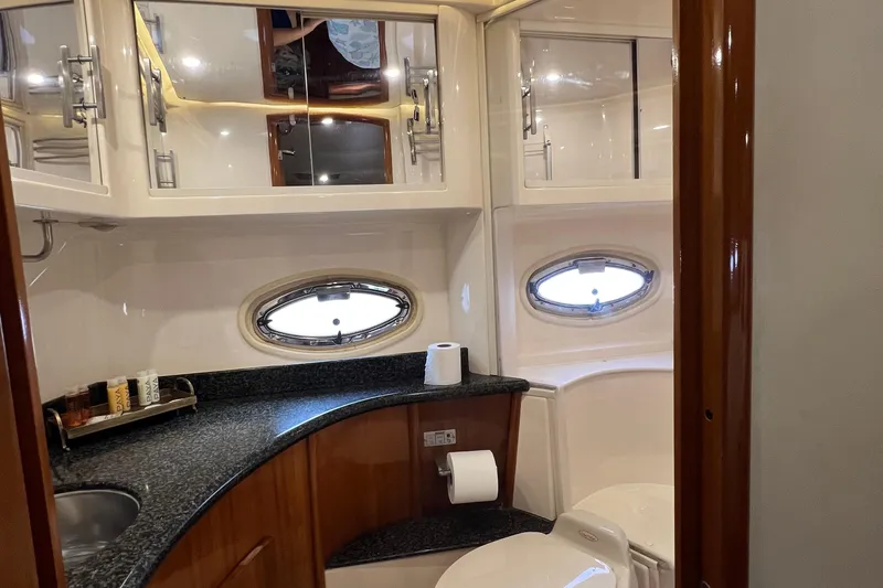 Slide: The Image of Luxurious bathroom interior of 2004 Carver 466 MY yacht with oval windows and sleek design. - 32