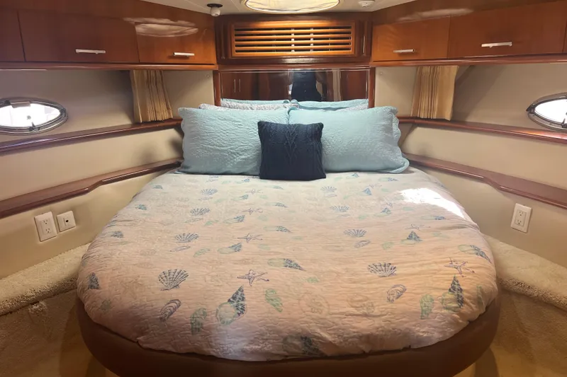 Slide: The Image of Luxurious 2004 Carver 466 MY yacht bedroom with elegant bedding and wood cabinetry. - 33