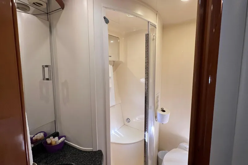 Slide: The Image of Bathroom interior of 2004 Carver 466 MY yacht, featuring shower and vanity area. - 34