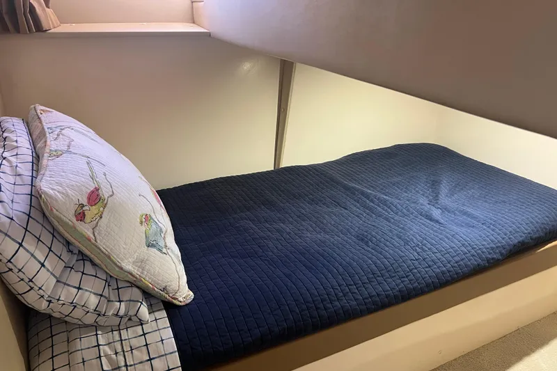 Slide: The Image of Cozy bunk bed in 2004 Carver 466 Motor Yacht with blue bedding and decorative pillow. - 35