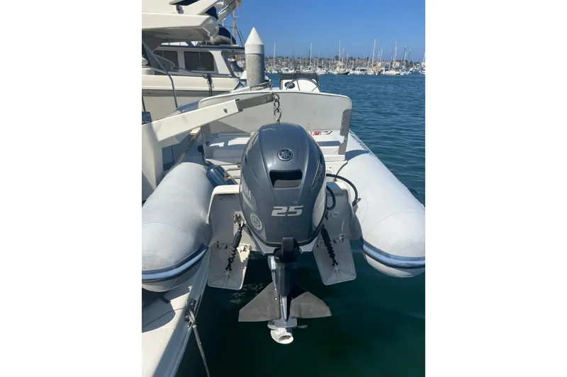 Slide: The Image of Inflatable boat with Yamaha 25 outboard motor, docked near Carver 466 Motor Yacht, 2004. - 37