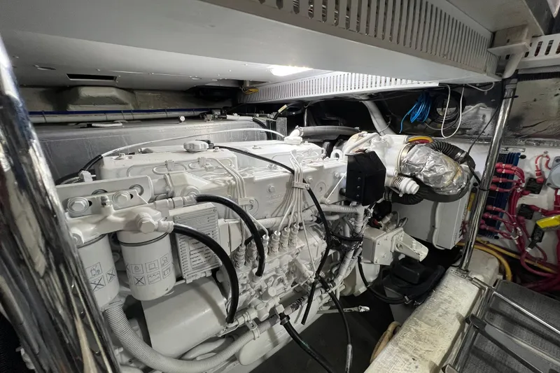Slide: The Image of Engine room of a 2004 Carver 466 Motor Yacht, showcasing detailed mechanical components. - 43