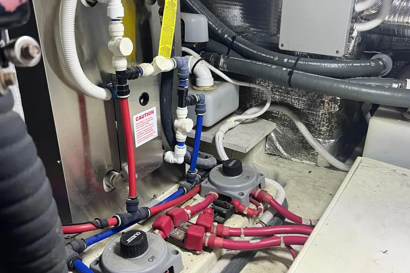 Slide: The Image of Engine room of 2004 Carver 466 Motor Yacht with plumbing and wiring systems. - 49