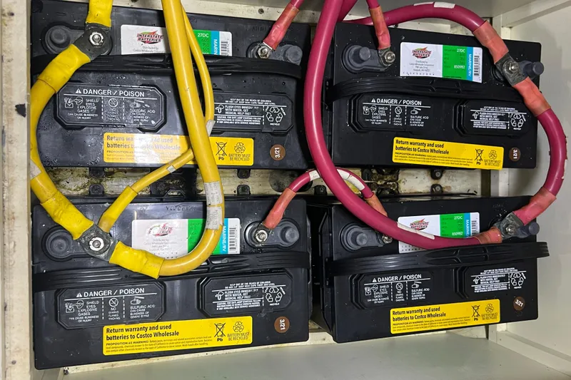 Slide: The Image of Four Interstate batteries with red and yellow cables in a 2004 Carver 466 MY. - 51