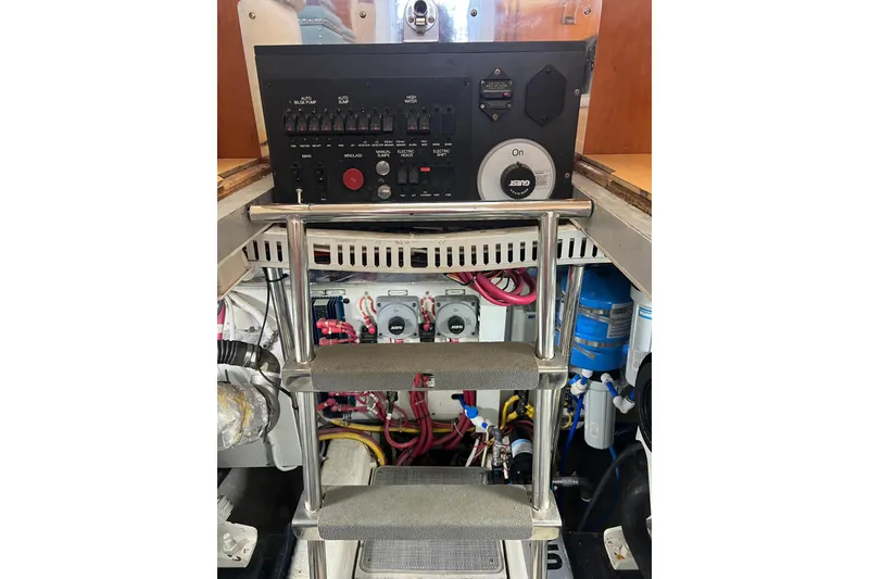 Slide: The Image of Engine room of 2004 Carver 466 MY yacht with control panel and ladder. - 55