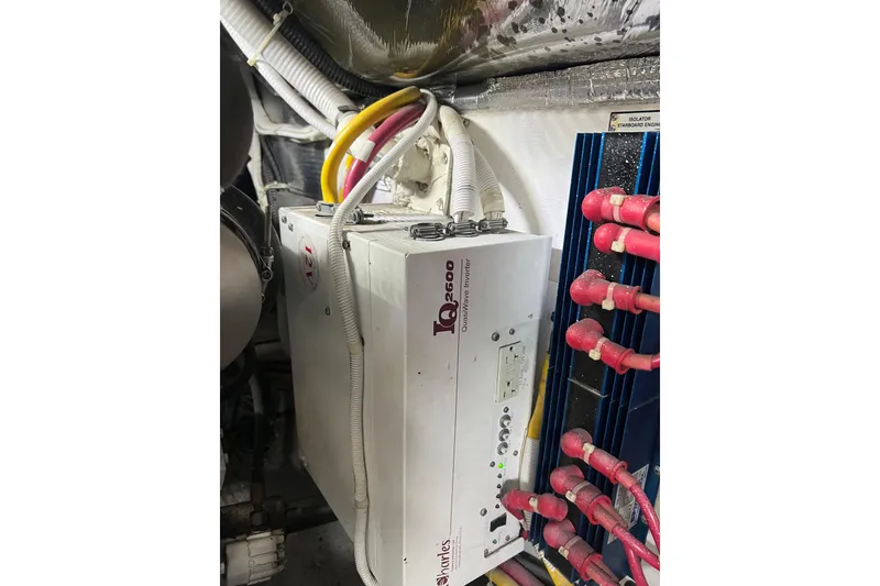 Slide: The Image of Electrical system in a 2004 Carver 466 MY yacht engine room with inverter and cables. - 58