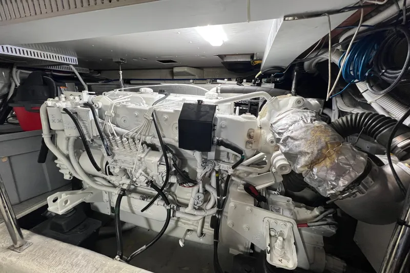 Slide: The Image of Engine room of a 2004 Carver 466 MY yacht, showcasing detailed machinery. - 59