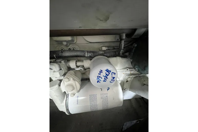 Slide: The Image of Engine component of a 2004 Carver 466 MY with visible filter and wiring. - 62