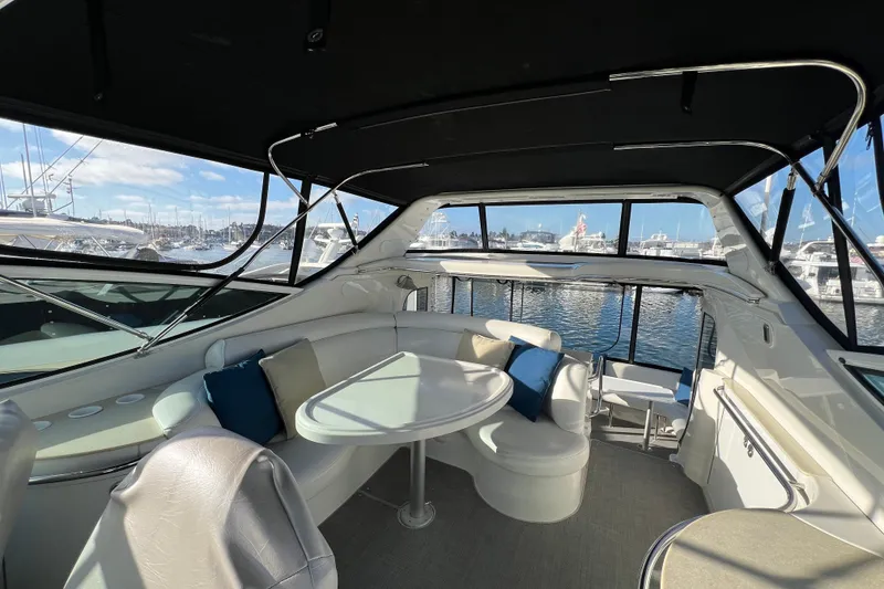 Slide: The Image of Luxurious 2004 Carver 466 MY yacht interior with seating and table, docked at marina. - 7