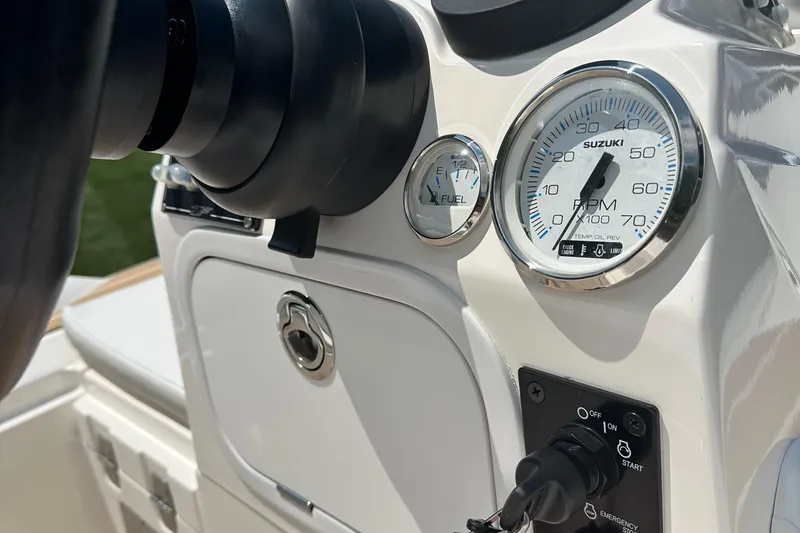 Slide: The Image of 2022 Zar Tender ZF0 boat dashboard with Suzuki RPM and fuel gauges. - 11