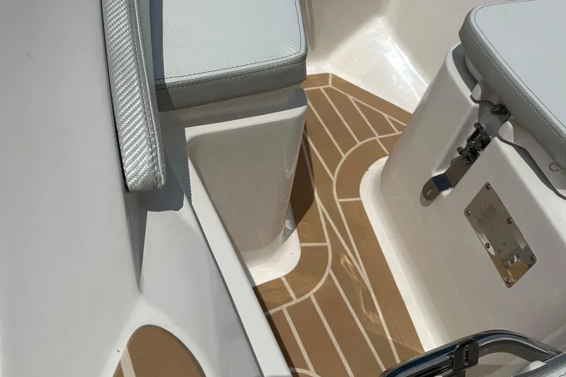 Slide: The Image of Interior of 2022 Zar Tender ZF0 boat with cushioned seating and wood-patterned flooring. - 13