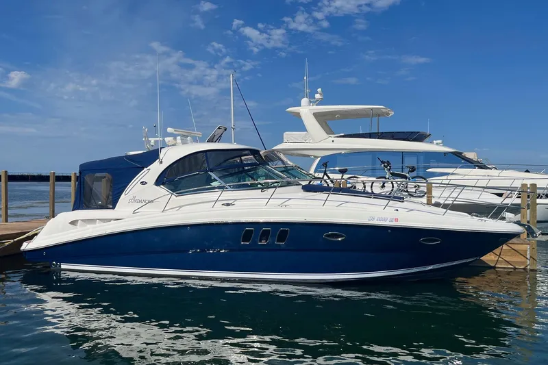 Slide: The Image of 2008 Sea Ray 380 Sundancer yacht docked at marina under clear blue sky. - 0
