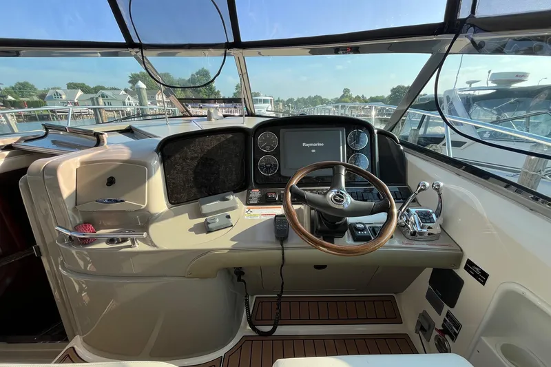 Slide: The Image of Helm of 2006 Sea Ray 380 Sundancer with steering wheel and navigation controls. - 11