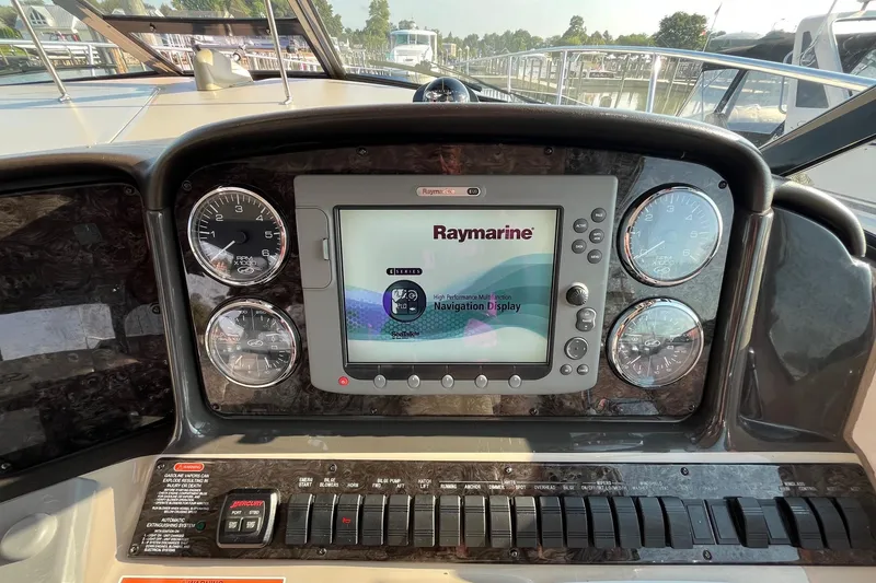 Slide: The Image of Dashboard of 2006 Sea Ray 380 Sundancer with Raymarine navigation display and gauges. - 12