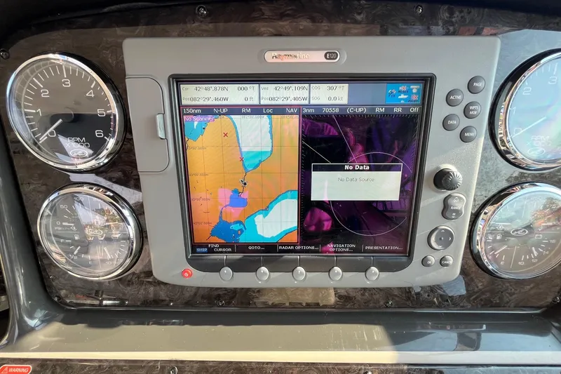 Slide: The Image of Dashboard of a 2006 Sea Ray 380 Sundancer with navigation display and gauges. - 14