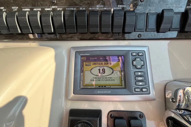 Slide: The Image of Control panel of 2006 Sea Ray 380 Sundancer showing critical depth warning. - 15