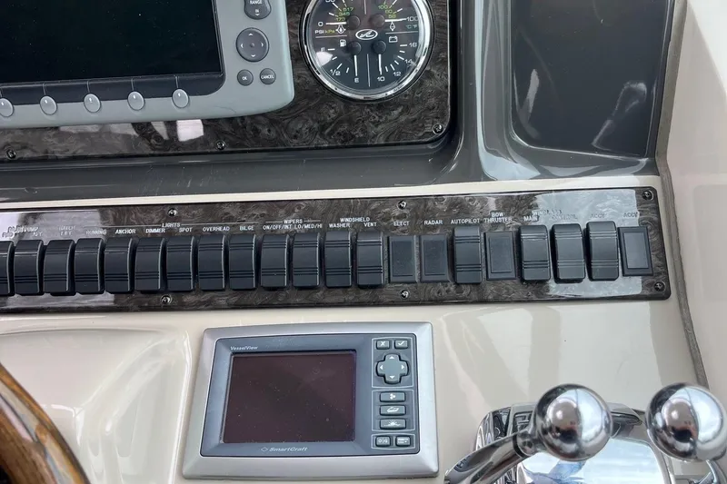 Slide: The Image of Control panel of a 2006 Sea Ray 380 Sundancer boat with switches and gauges. - 16