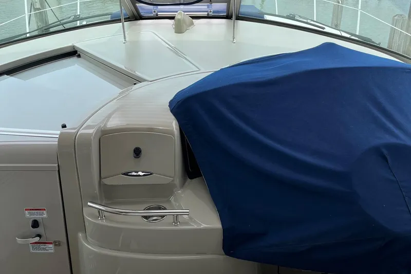 Slide: The Image of 2006 Sea Ray 380 Sundancer boat interior with blue cover and control panel. - 17