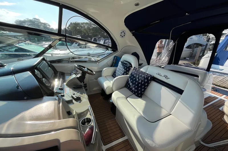 Slide: The Image of 2006 Sea Ray 380 Sundancer cockpit with luxurious seating and modern dashboard. - 18