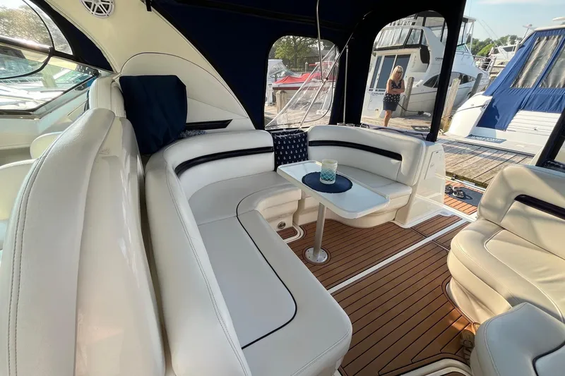Slide: The Image of Interior of 2006 Sea Ray 380 Sundancer yacht with white seating and wooden flooring. - 19