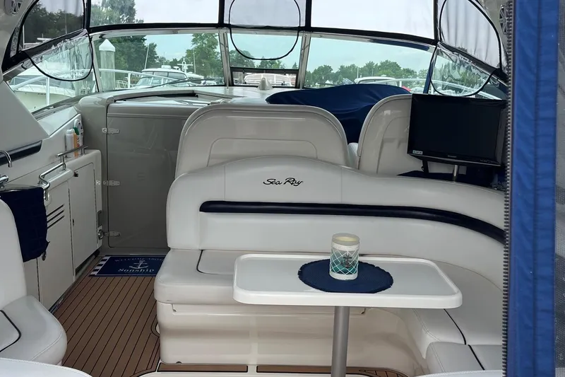 Slide: The Image of 2006 Sea Ray 380 Sundancer interior with seating, table, and TV. - 25