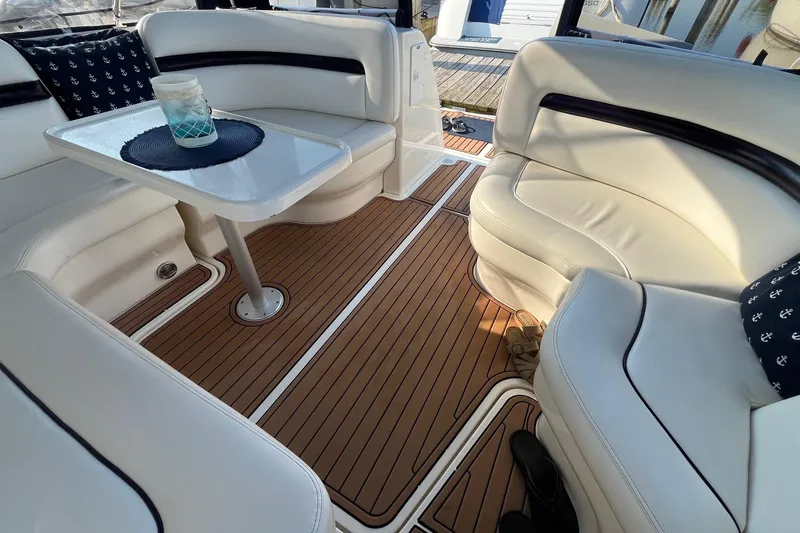 Slide: The Image of Interior of 2006 Sea Ray 380 Sundancer with white seating and wooden flooring. - 27