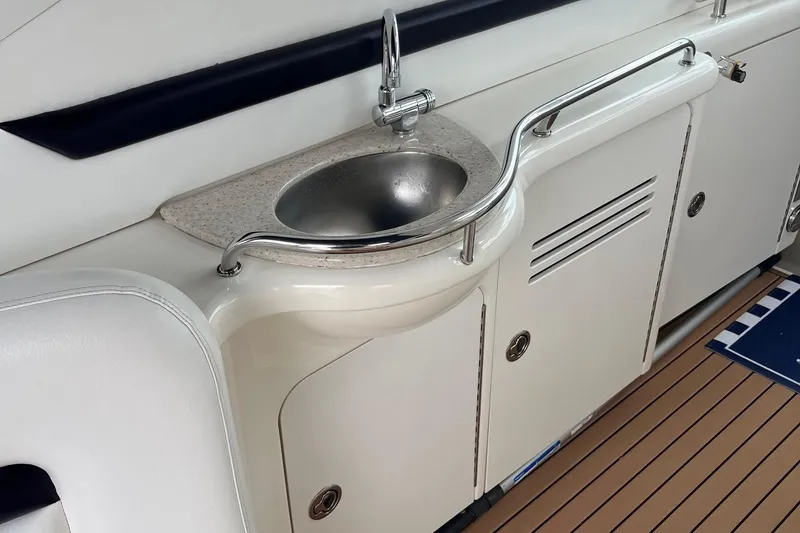 Slide: The Image of 2006 Sea Ray 380 Sundancer yacht interior with sink and storage cabinets. - 29
