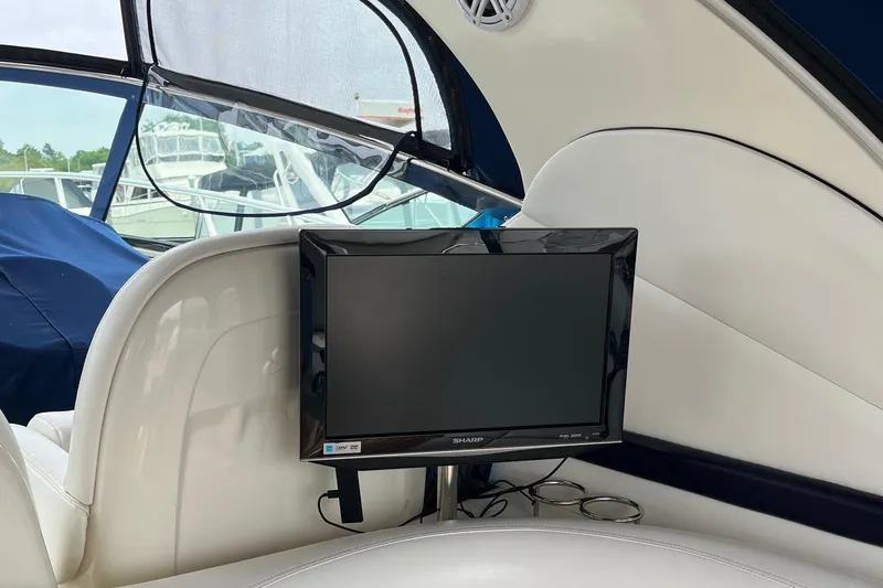 Slide: The Image of Interior of 2006 Sea Ray 380 Sundancer with mounted Sharp TV and white seating. - 30