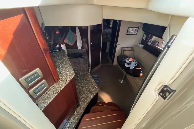 Slide: The Image of Interior of 2006 Sea Ray 380 Sundancer yacht with modern kitchen and seating area. - 31