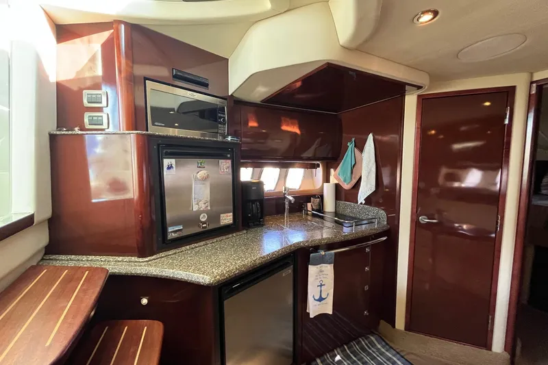 Slide: The Image of Luxurious 2006 Sea Ray 380 Sundancer yacht interior with modern kitchen amenities. - 32