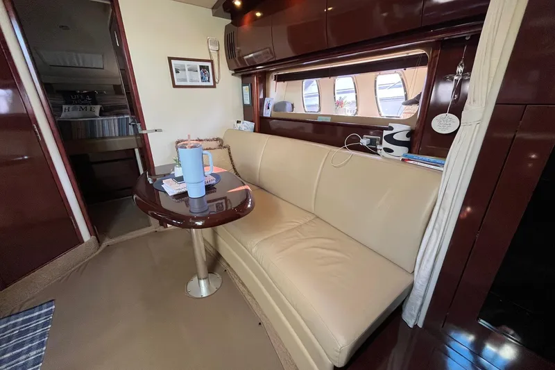 Slide: The Image of Interior of 2006 Sea Ray 380 Sundancer yacht with beige seating and wooden accents. - 33