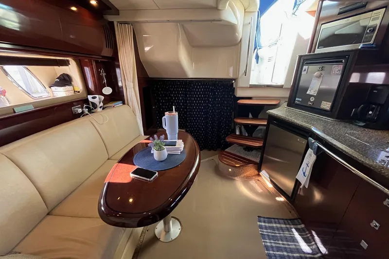 Slide: The Image of Interior of 2006 Sea Ray 380 Sundancer yacht with elegant seating and kitchenette. - 34
