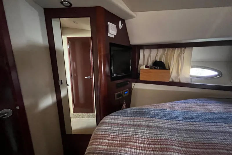 Slide: The Image of Cozy cabin interior of 2006 Sea Ray 380 Sundancer with striped bedding and decorative pillows. - 38