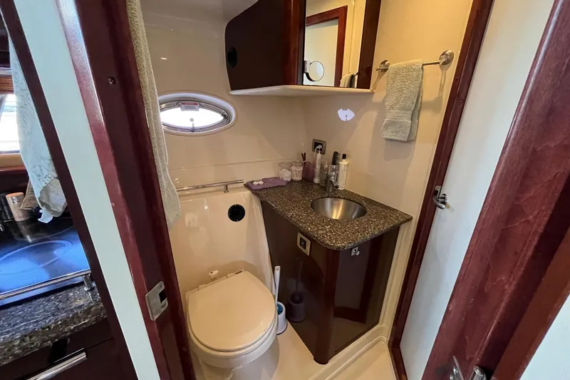 Slide: The Image of Cozy cabin interior of 2006 Sea Ray 380 Sundancer with striped bedding and decorative pillows. - 39