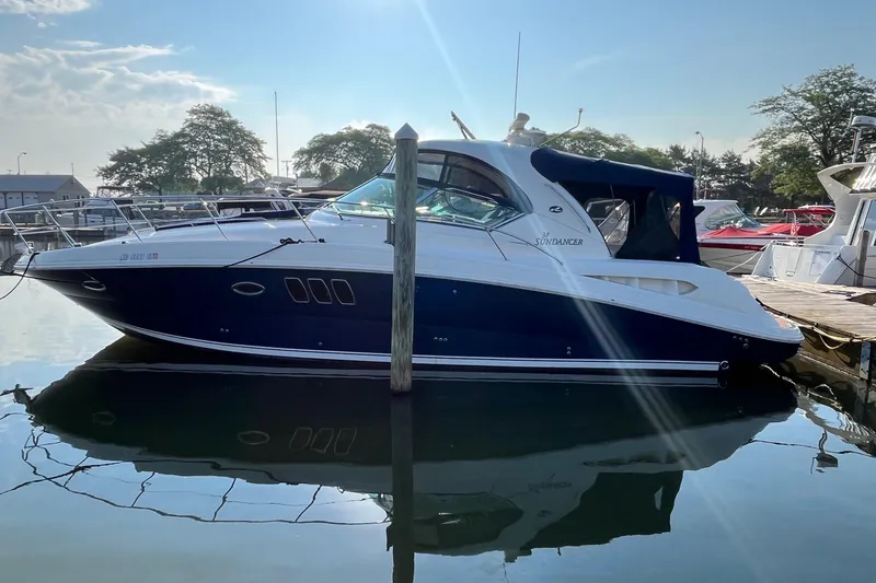 Slide: The Image of 2006 Sea Ray 380 Sundancer yacht docked in a marina under clear skies. - 4