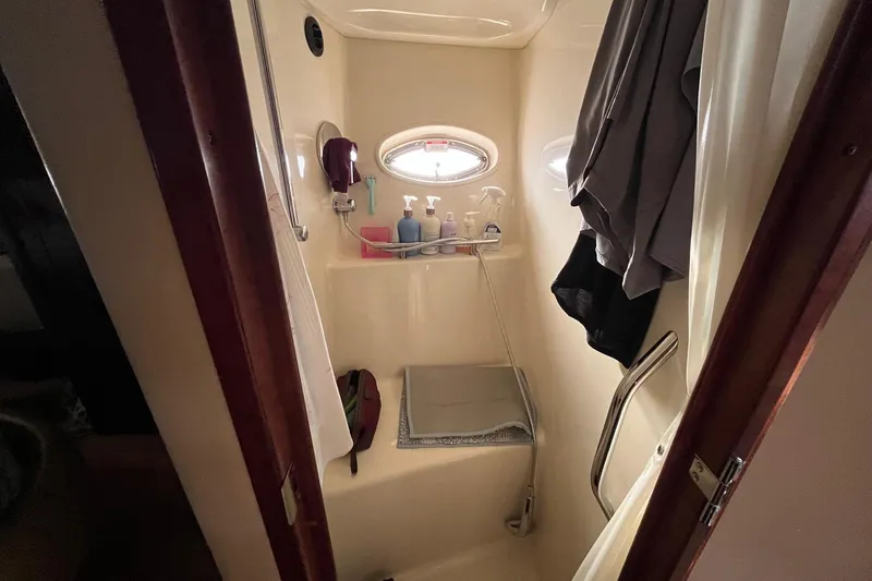 Slide: The Image of Cozy cabin interior of 2006 Sea Ray 380 Sundancer with bed, TV, and porthole window. - 40