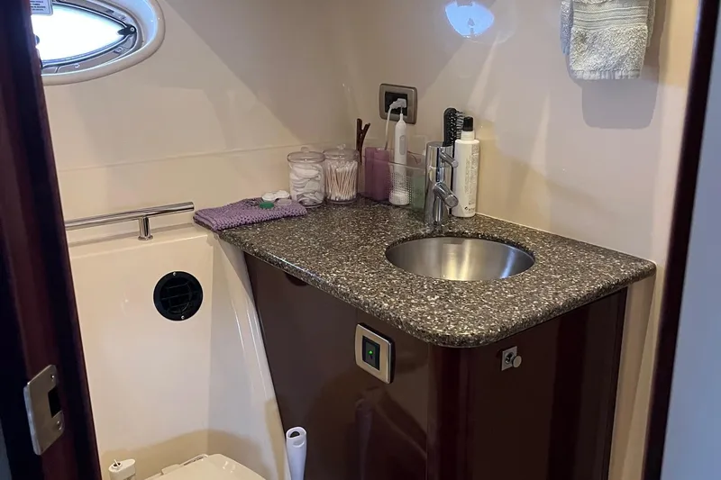 Slide: The Image of Compact bathroom in 2006 Sea Ray 380 Sundancer yacht with toiletries and porthole window. - 42